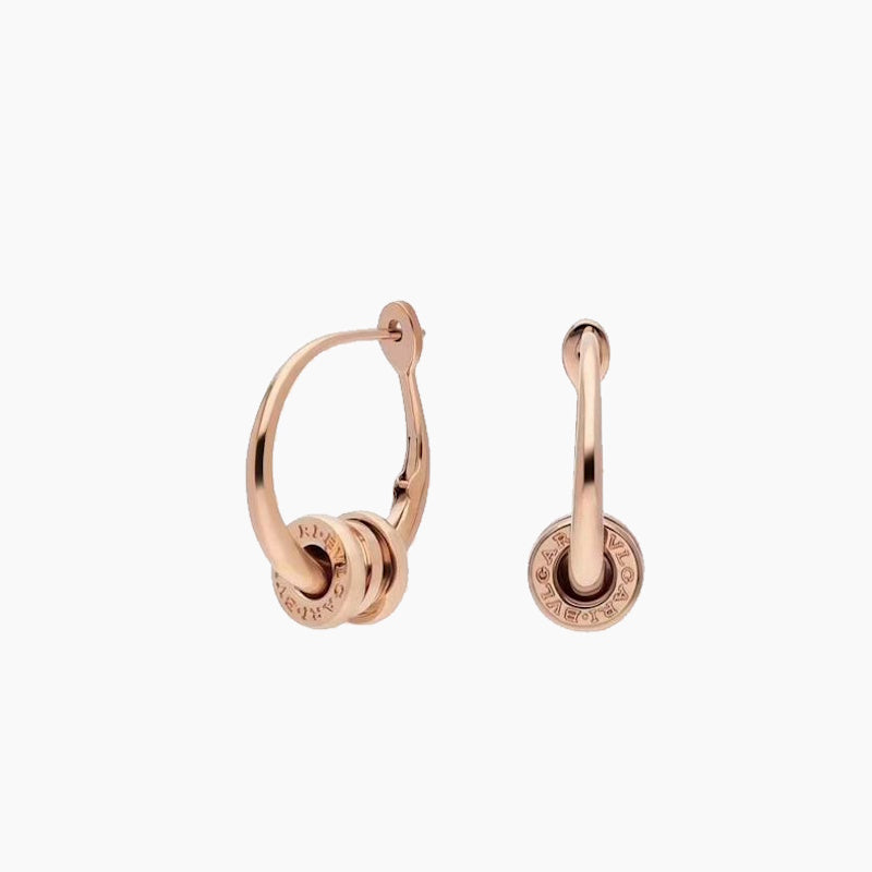 A pair of rose gold hoop earrings with a stacked circular disc design on the front, shown from both the front and side angles against a light gray background.