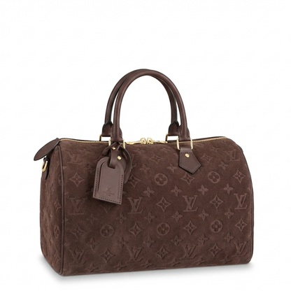 A brown monogram canvas duffel bag with dark brown leather handles and gold-tone hardware, shown on a clean white background.