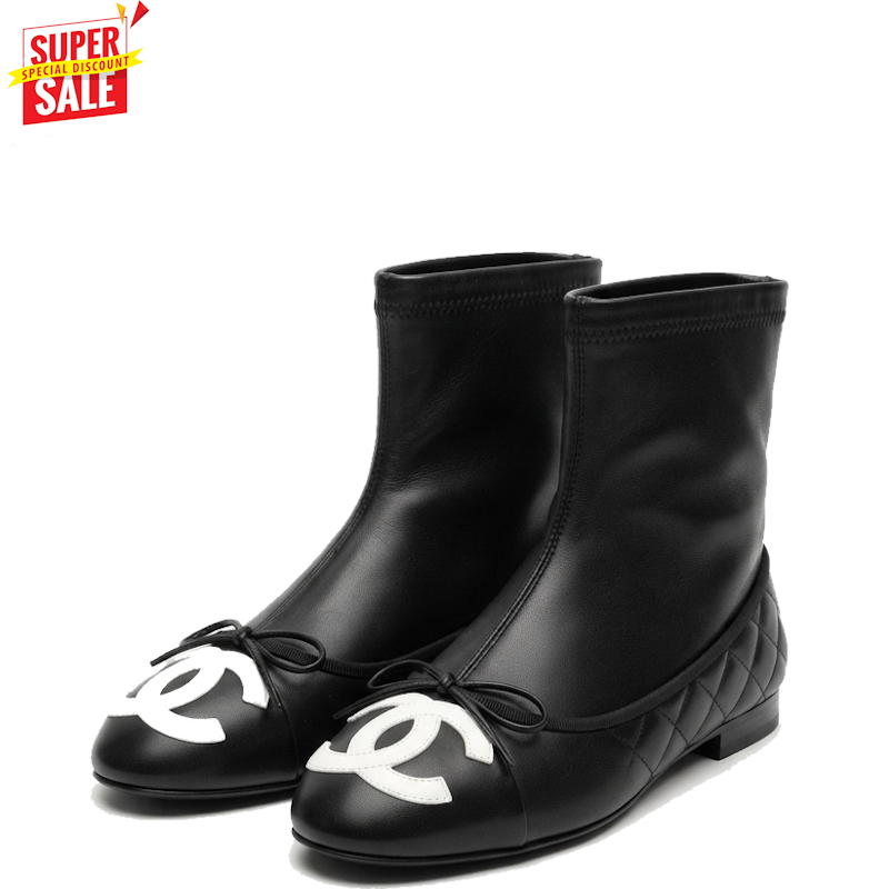 A pair of black leather ankle boots with white interlocking CC logos on the toes, bow details, and quilted soles, shown on a white background with a red 'SUPER SALE' graphic in the top-left corner.