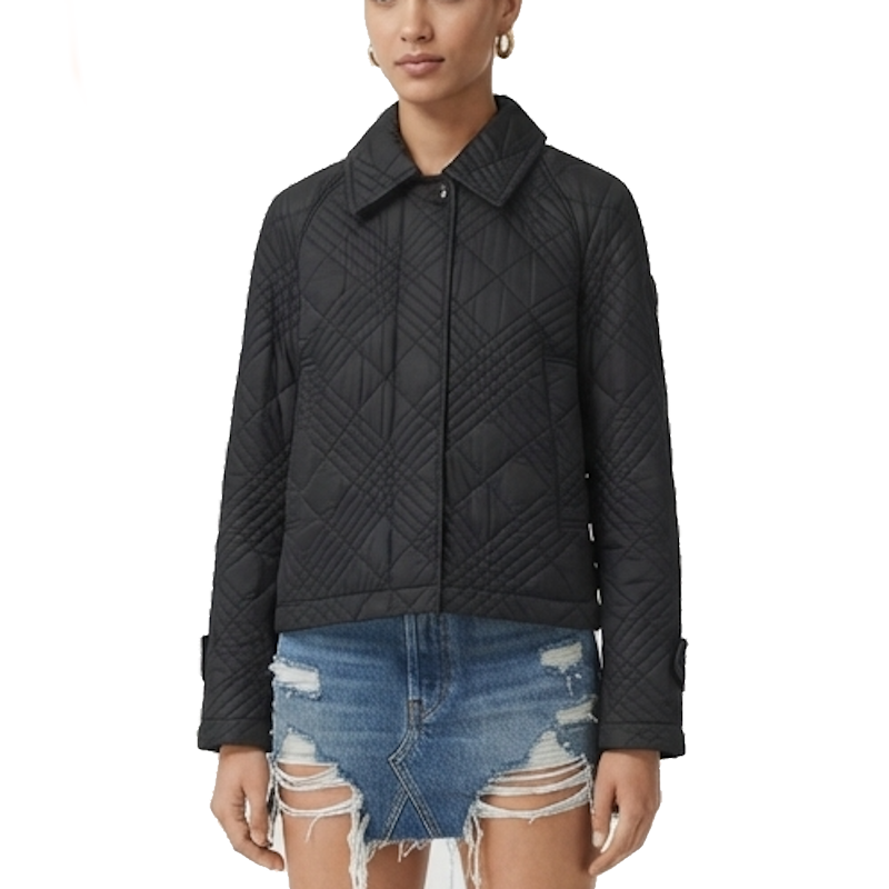 A model wearing a black quilted jacket with a diamond pattern, paired with distressed denim shorts, against a plain white background.