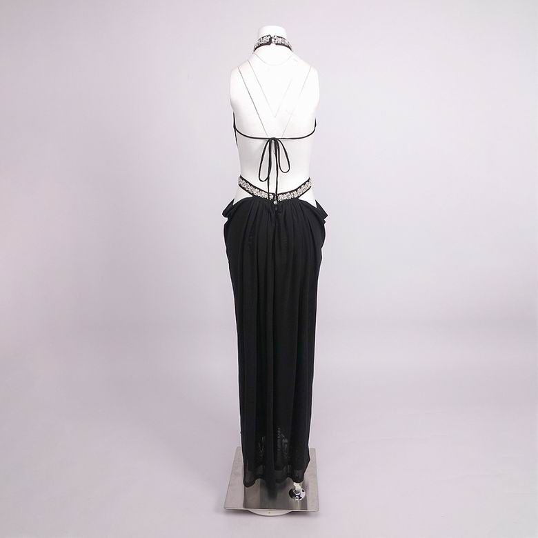 A black pleated maxi skirt with a sheer black mesh overlay and lace trim at the hem, displayed on a white mannequin torso against a light gray studio background.