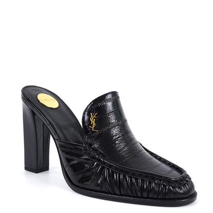 A black leather high-heeled mule slipper with a textured crocodile-embossed pattern, featuring a gold-tone Y logo on the side and a gold insole label, shown against a plain white background.