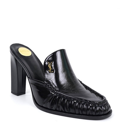 A black leather mule shoe with a block heel, featuring a gold-tone Y logo on the side and a gold insole, shown against a plain white background.