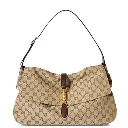 A beige and brown GG Supreme canvas shoulder bag with a dark brown leather strap and a gold-tone turn-lock clasp on a white background.