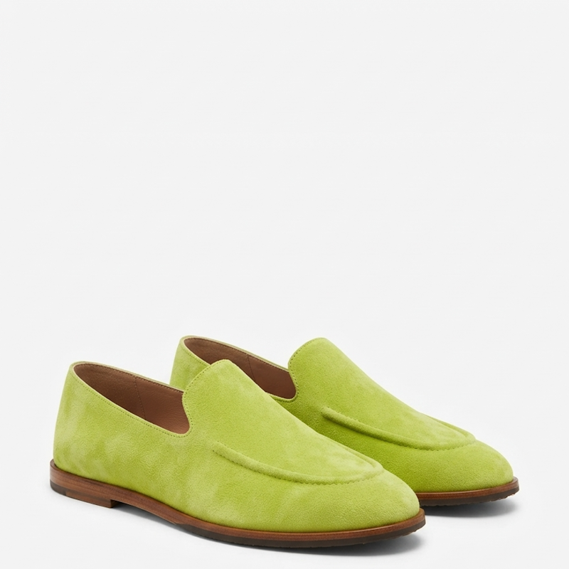 A pair of lime green suede slip-on loafers with brown soles, displayed on a clean white background.