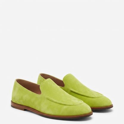 A pair of lime green suede slip-on loafers with brown soles, displayed on a clean white background.