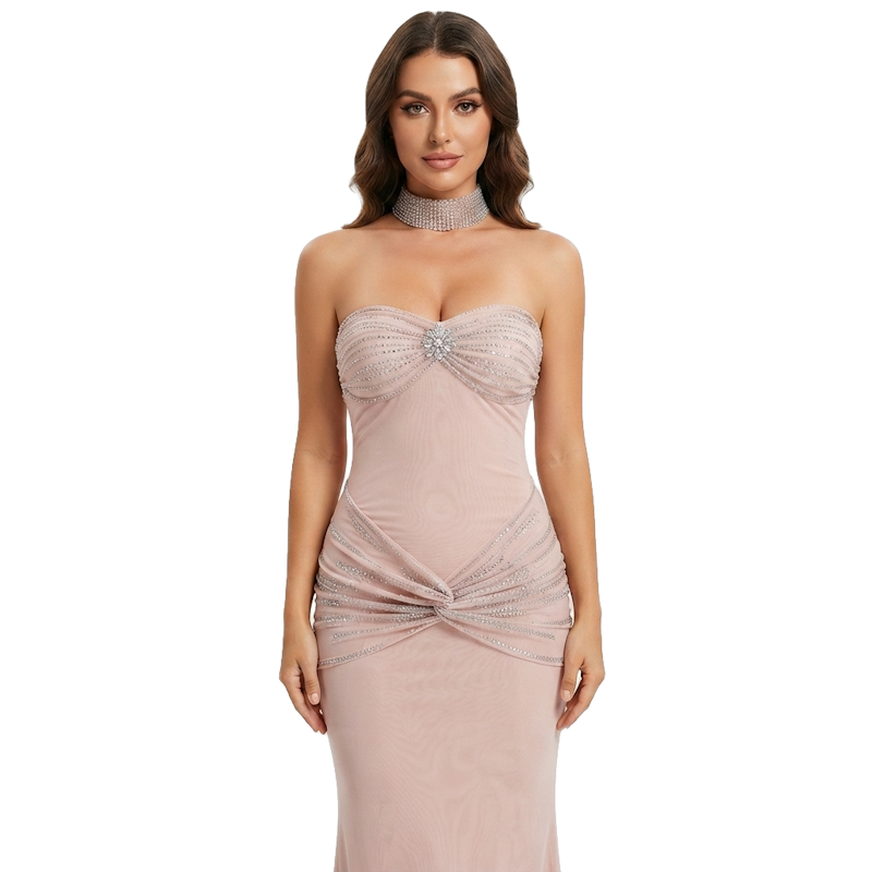 A woman modeling a strapless blush pink evening gown with a sweetheart neckline, embellished beading on the bodice, a matching beaded choker, and a ruched twist detail at the waist.