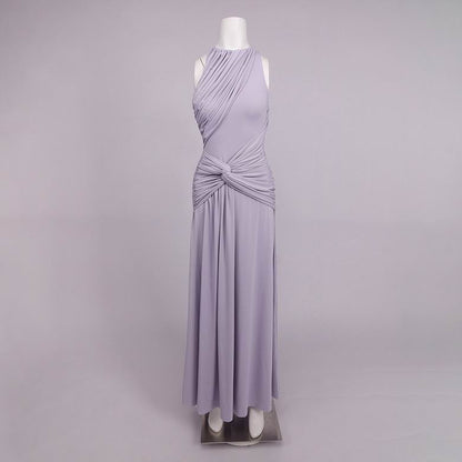 A sleeveless lavender maxi dress with draped wrap-style detailing and a twisted waist, displayed on a white mannequin against a light gray studio background.
