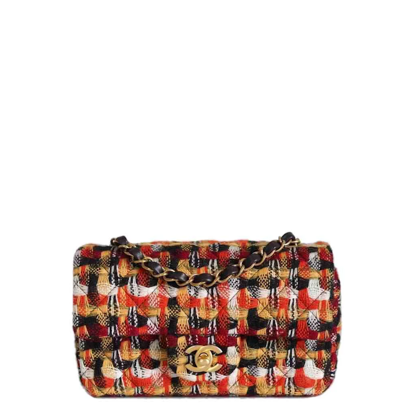  double-flap shoulder bag in a vibrant multicolor tweed and leather pattern, featuring a gold-tone interlocking CC logo and a gold chain strap, set against a plain white background.