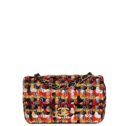 double-flap shoulder bag in a vibrant multicolor tweed and leather pattern, featuring a gold-tone interlocking CC logo and a gold chain strap, set against a plain white background.