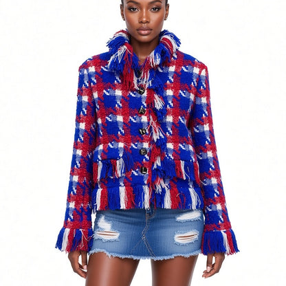 A model wearing a red, white, and blue plaid fringed tweed jacket with a high collar and distressed denim mini skirt against a plain white background.