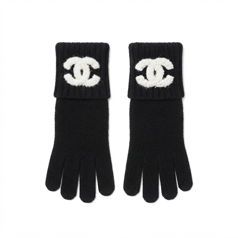 A pair of black knit gloves with white logo patches on the cuffs, displayed flat against a white background.
