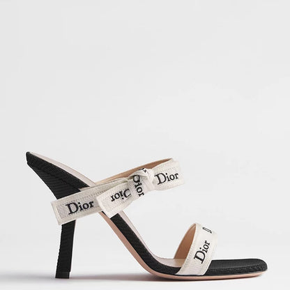A single slingback sandal with a black textured toe cap and heel, and off-white straps featuring the Dior logo, shown against a light gray background.