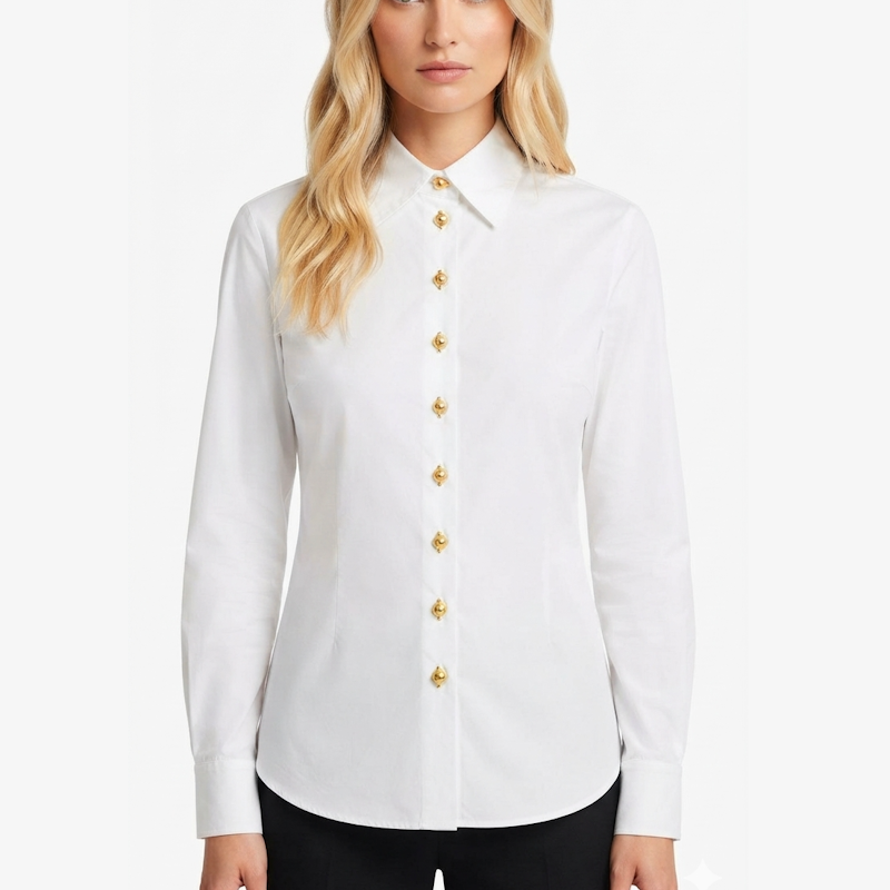 A woman wearing a white long-sleeve button-up shirt with decorative gold buttons down the front, paired with black pants, against a plain white background.