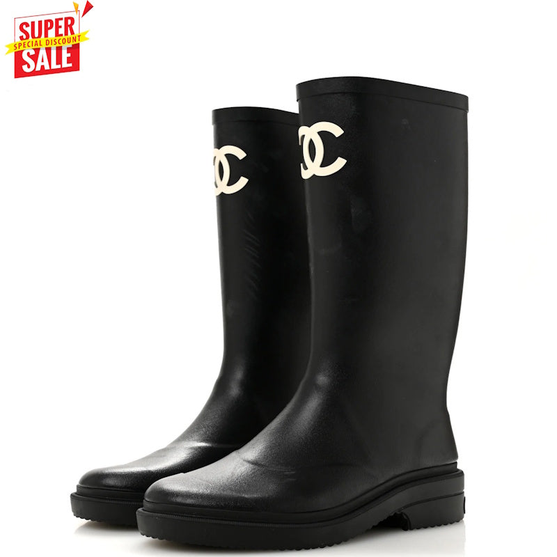 A pair of black rubber rain boots with the interlocking CC logo of Chanel in gold on the upper shaft, shown on a white background with a red 'SUPER SALE' graphic in the top-left corner.