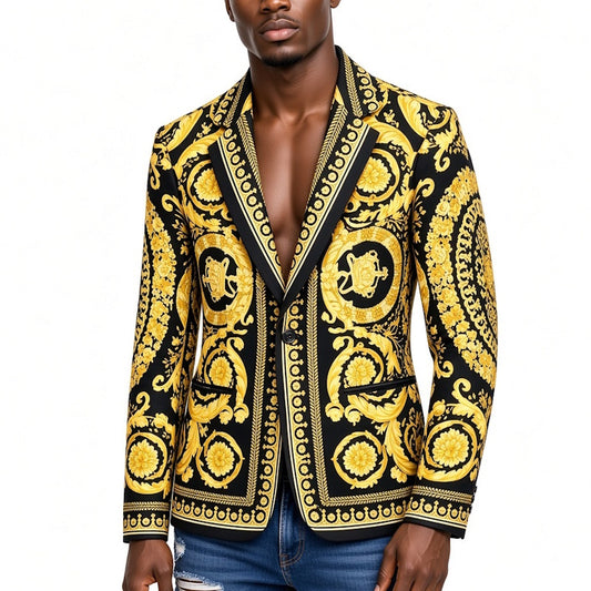 A man wearing a black and gold baroque-patterned blazer jacket, paired with blue jeans, against a plain white background.