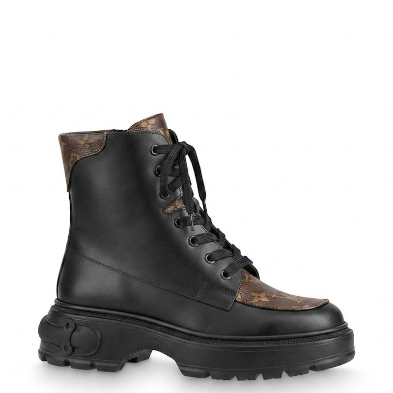 A black leather lace-up ankle boot with brown patterned leather panels on the toe and collar, featuring a chunky black sole, shown against a plain white background.