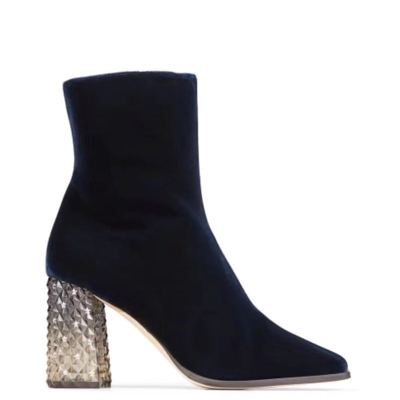 A navy blue velvet ankle boot with a pointed toe and a textured metallic silver block heel, shown in profile against a white background.
