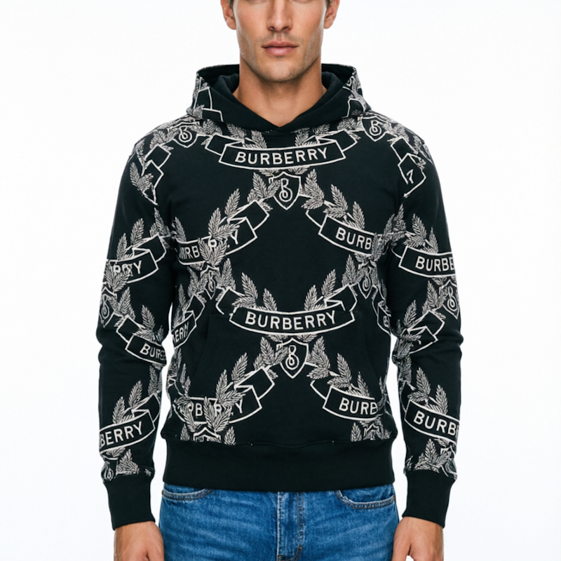 A man wearing a black Buber hoodie with a white allover logo print, paired with blue jeans, against a plain white background.