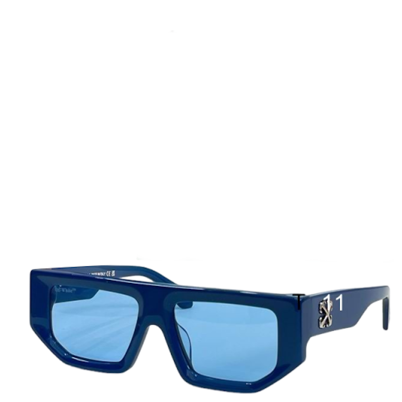 A pair of designer sunglasses with a bold, angular dark blue acetate frame and light blue lenses. The right temple arm features a silver-tone '1' emblem and the brand name 'SOL'S' on the inner side, indicating the brand Sol's.