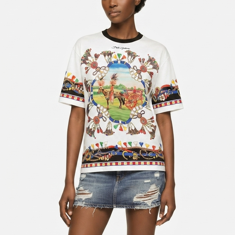 A model wearing a white graphic t-shirt with a colorful Native American-inspired design and distressed denim shorts, set against a plain light gray background.