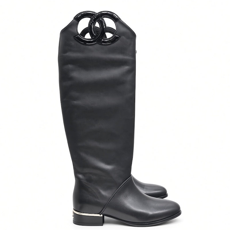 A single black leather knee-high boot with a glossy black interlocking double-O ring detail at the top, shown from a side profile on a white background.