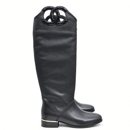 A single black leather knee-high boot with a glossy black interlocking double-O ring detail at the top, shown from a side profile on a white background.