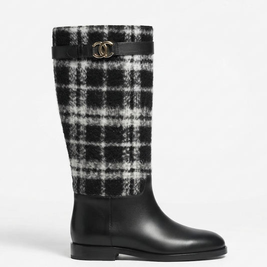 A knee-high boot featuring a black and white plaid wool upper and a smooth black leather lower section, accented by a black leather strap with a gold-tone interlocking CC logo buckle.