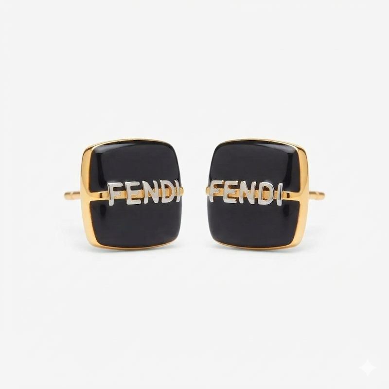 A pair of Fendi square cufflinks with black enamel faces, gold-tone metal borders, and the Fendi logo in silver-tone lettering across the center, set against a plain light gray background.