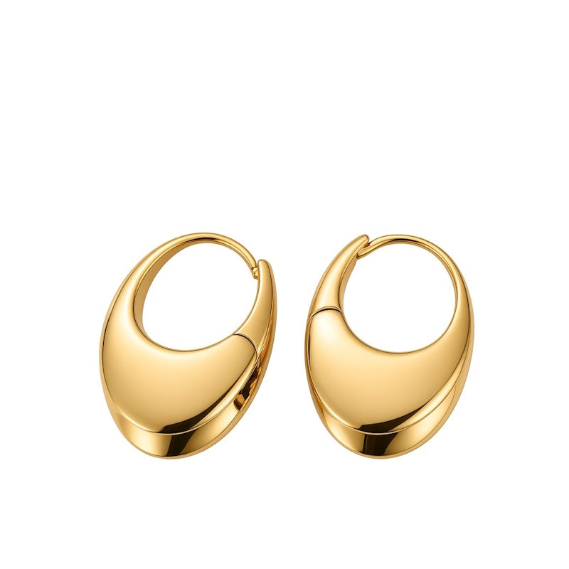 A pair of polished gold crescent-shaped hoop earrings on a solid white background.