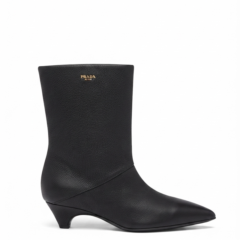 A black  leather ankle boot with a pointed toe and a low kitten heel, shown from a side profile on a white background.