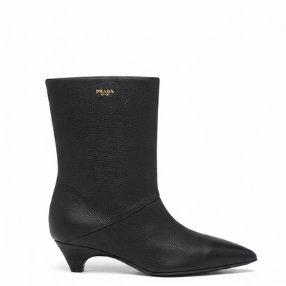 A black  leather ankle boot with a pointed toe and a low kitten heel, shown from a side profile on a white background.