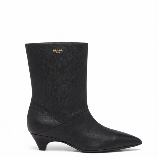 A black  leather ankle boot with a pointed toe and a low kitten heel, shown from a side profile on a white background.
