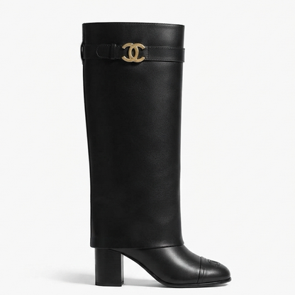 A black leather knee-high boot with a block heel and a gold-tone interlocking CC logo buckle at the top, shown from a side profile on a white background.