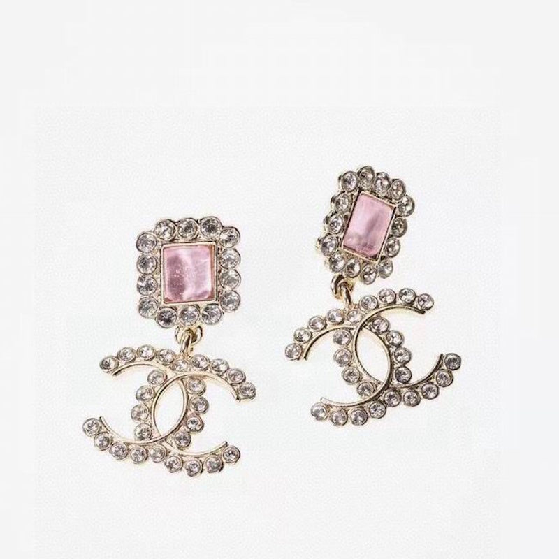 A pair of gold-tone drop earrings featuring a square pink rhinestone top and a lower interlocking CC motif encrusted with clear rhinestones.