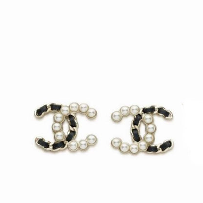 A pair of CC logo stud earrings featuring black and white leather trim, white faux pearls, and silver-tone metal settings, shown on a plain white background.