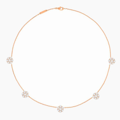 A delicate rose gold chain necklace featuring five small, round cluster floral motifs set with clear stones, displayed on a clean white background.